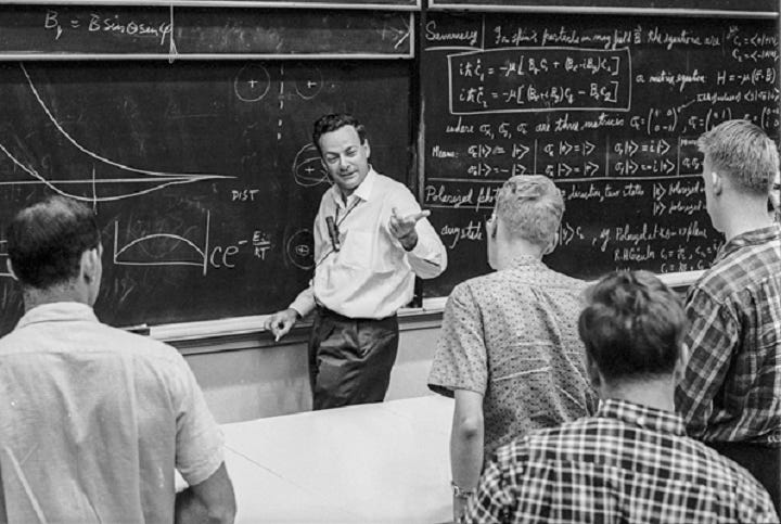 Richard Feynman lecturing at a chalkboard